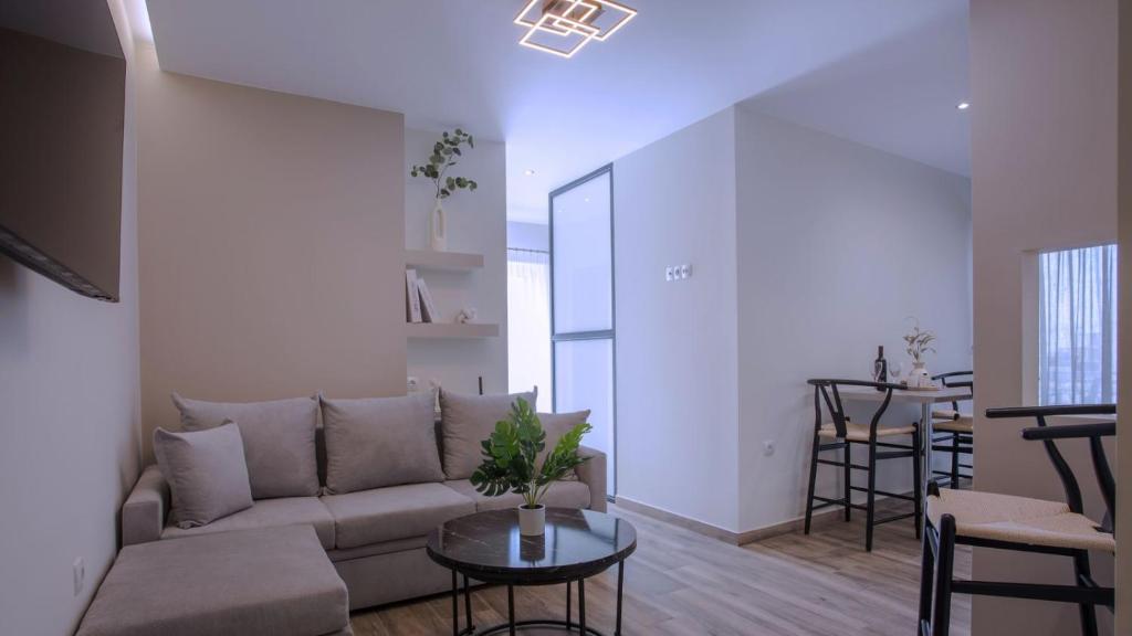 a living room with a couch and a table at Orelia Suite 3 in Karistos