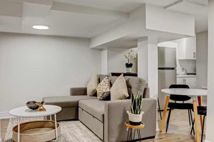 a living room with a couch and two tables at Cozy 1 Br Apt with TV, Workstation, Kitchenette & Parking in Mississauga