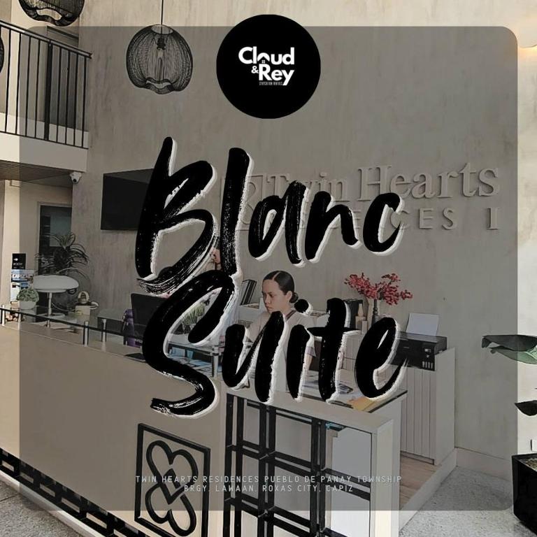 a woman sitting at a counter with a sign that reads bloke hearts sing at Blanc Suite in Roxas City