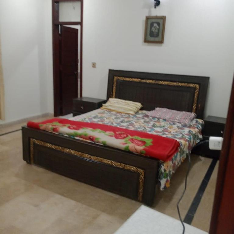 a bedroom with a bed with a red blanket at Sunset Lodges Bhurban in Bhurban