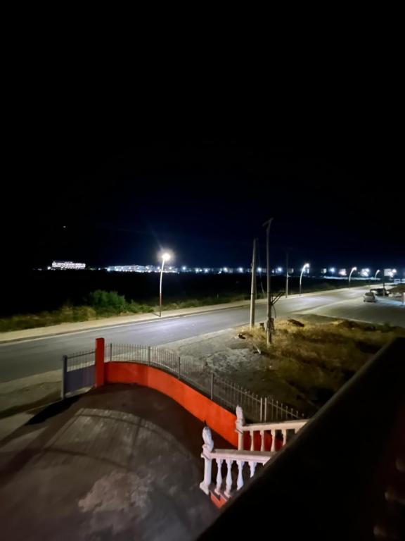 an empty road at night with street lights at Zefigrillhouse in Tale