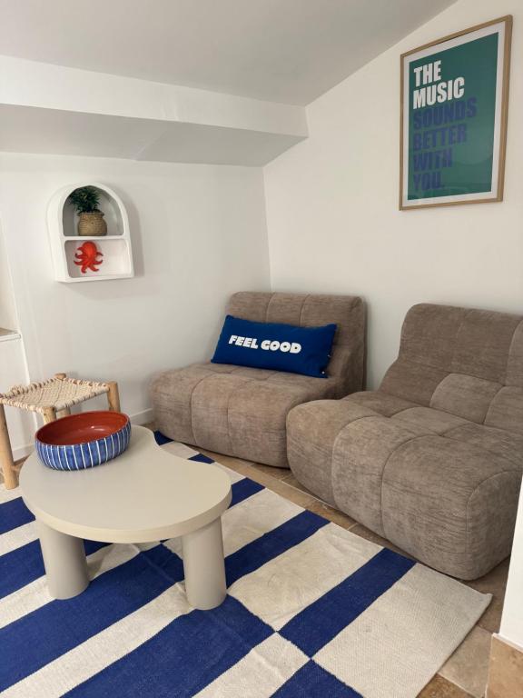 a living room with a couch and a coffee table at Santorin étoilé- hyper centre in Sanary-sur-Mer