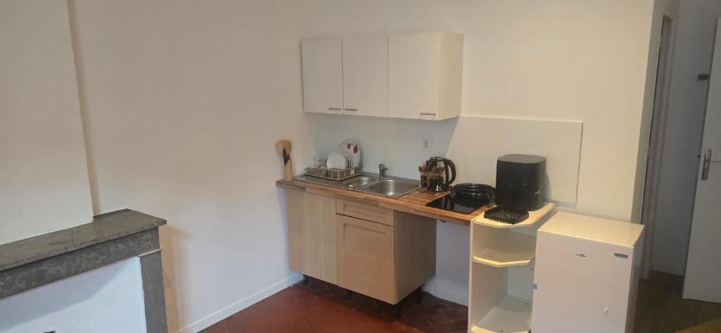 a small kitchen with a sink and a counter at Olti in Avignon