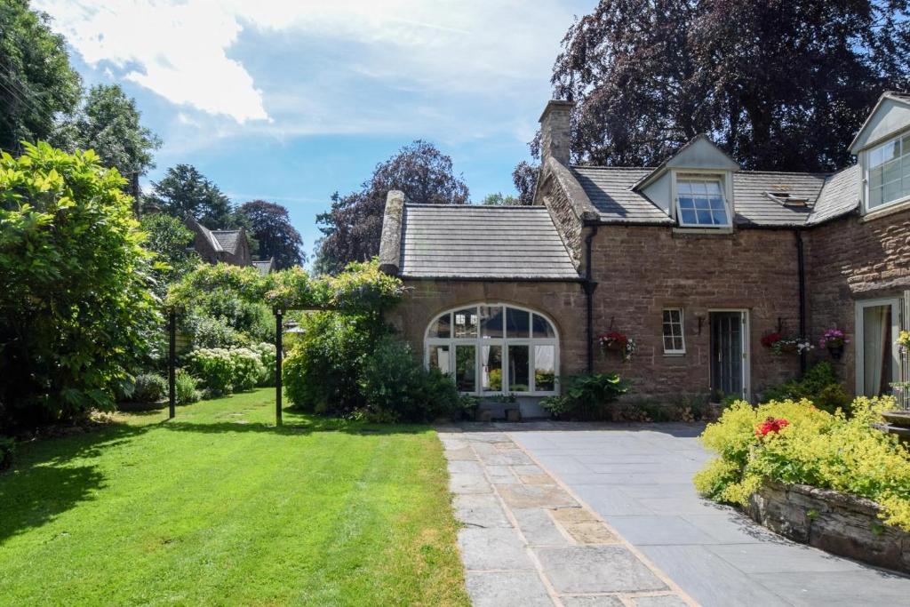 an exterior view of a brick house with a lawn at 2 Bed in Bromyard oc-27478 in Pencombe