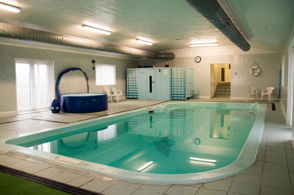 a large swimming pool in a large room at The Mansion in Whitehaven