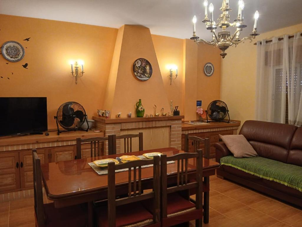 a living room with a dining table and a television at Casa rural el cerrete in Riópar