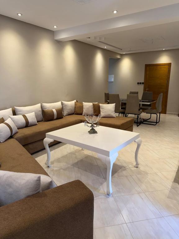 a living room with a couch and a table at Panoramic Sea View Apartment in Riffiene