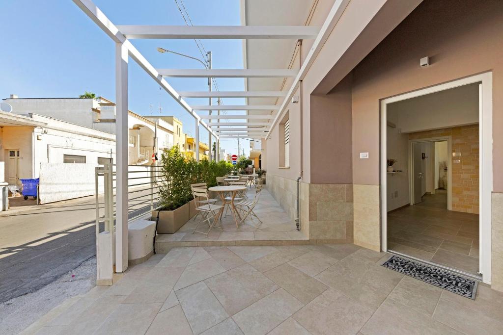 a patio with a table and chairs on a building at L'Aurora Bed and Breakfast in Ugento