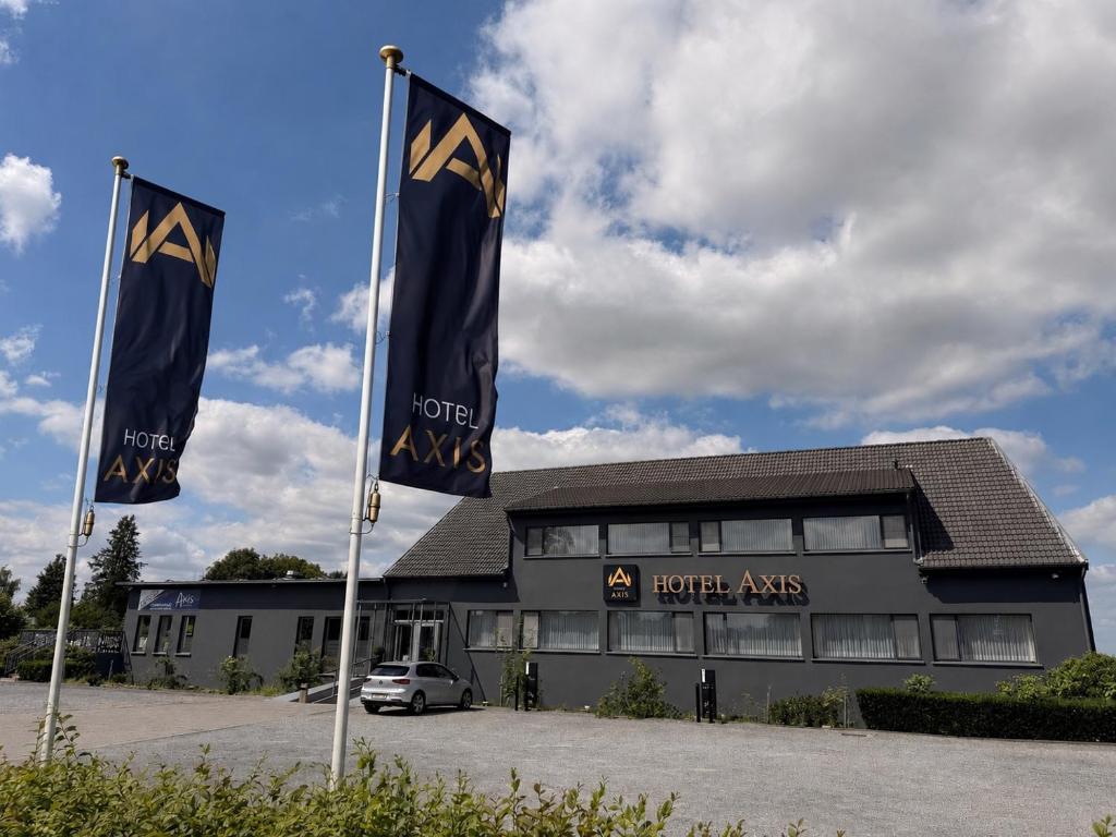 two flags in front of a hotel arts at Axis Hotel Brussels Airport in Kortenberg