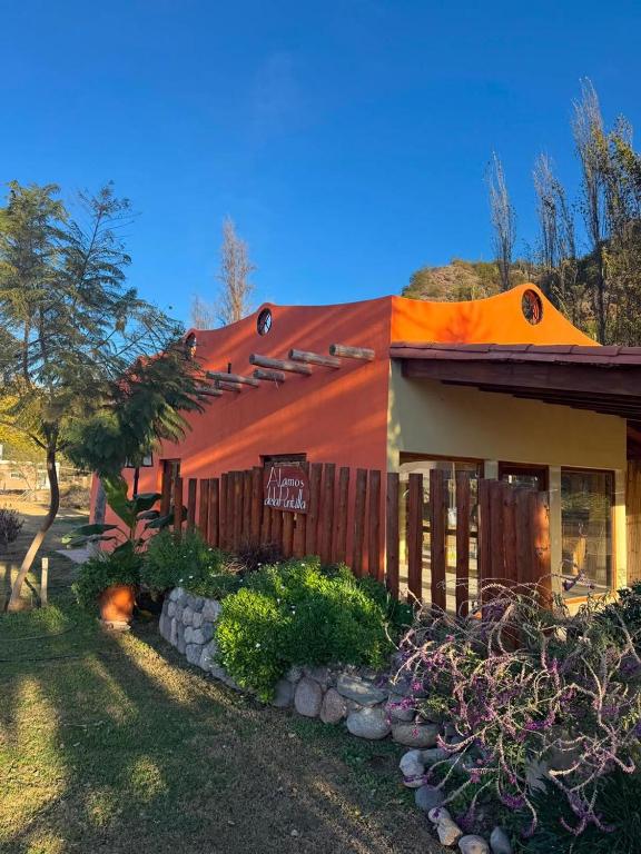 a house with an orange roof and a fence at Hotel alamos de la puntilla in Belén