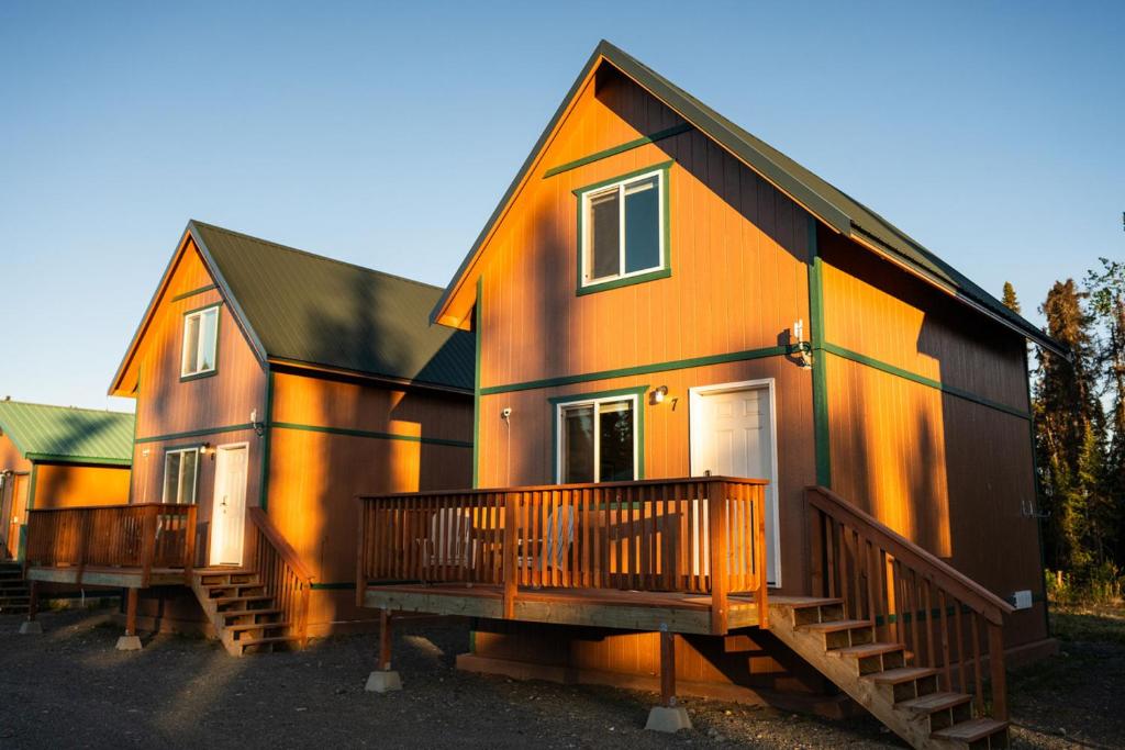 an orange and black house with two decks at Halibut Haven, Cabin 7 at Lower Kenai Lodge in Kenai