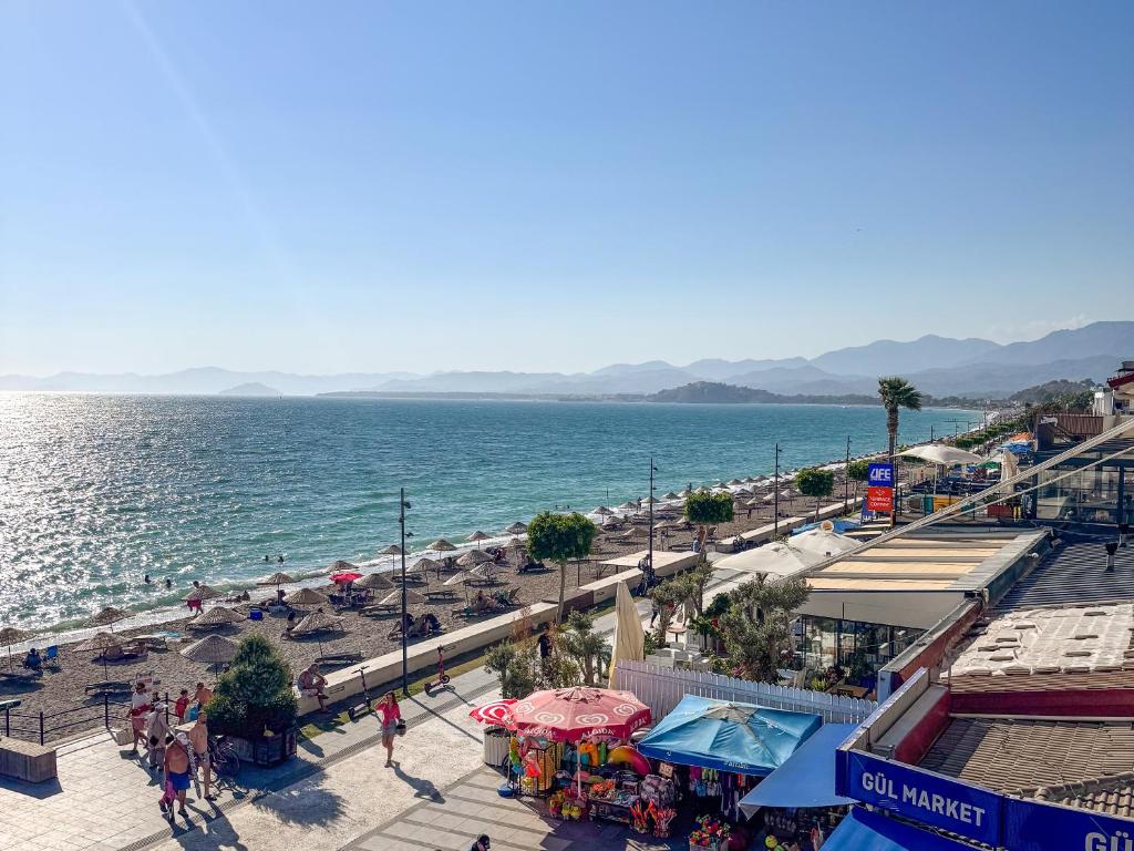 a view of a beach with people and the ocean at Er-öz Hotel & Restaurant in Fethiye