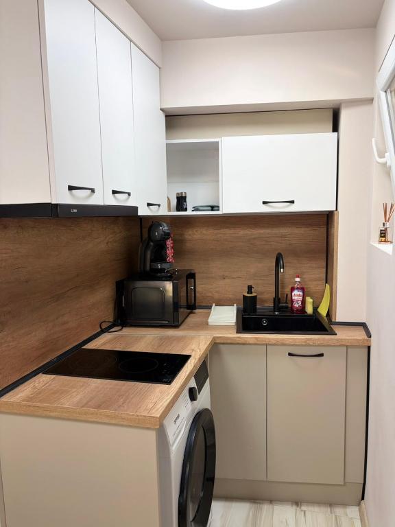 a kitchen with a sink and a washing machine at Little Studio Prespa Best Location in Varna City