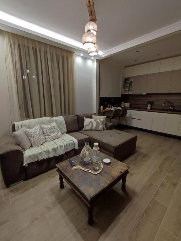 a living room with a couch and a coffee table at Evita's House in Doxato