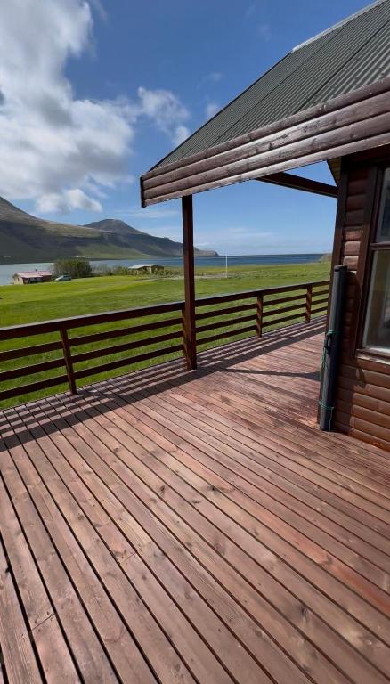 a large wooden deck next to a building at Olga Apartments in Grundarfjordur