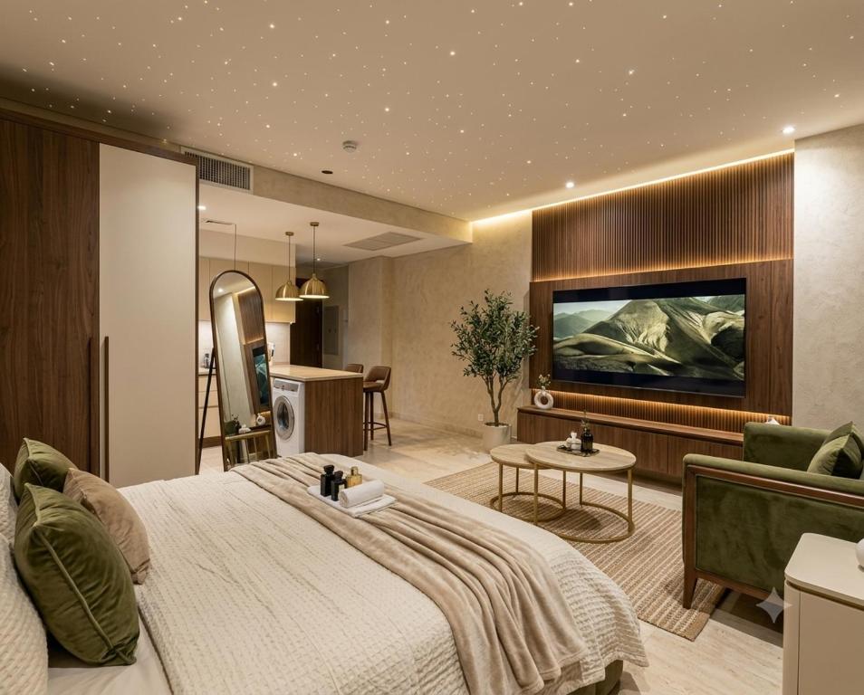 a bedroom with a large bed and a living room at Hotel Mashabrum Skardu in Skardu