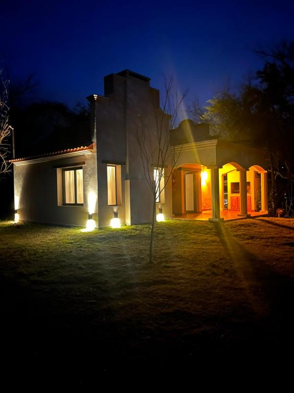 a house with lights on the side of it at night at Casa Tala in Villa Las Rosas