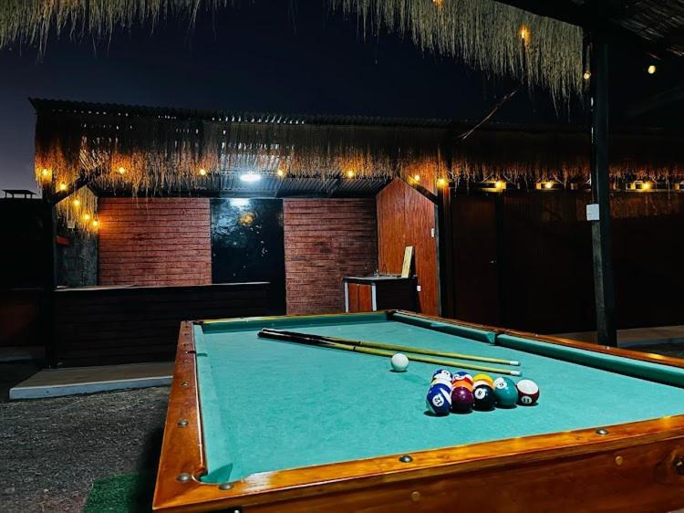 a pool table with balls on top of it at Taltal - Cabañas in Taltal