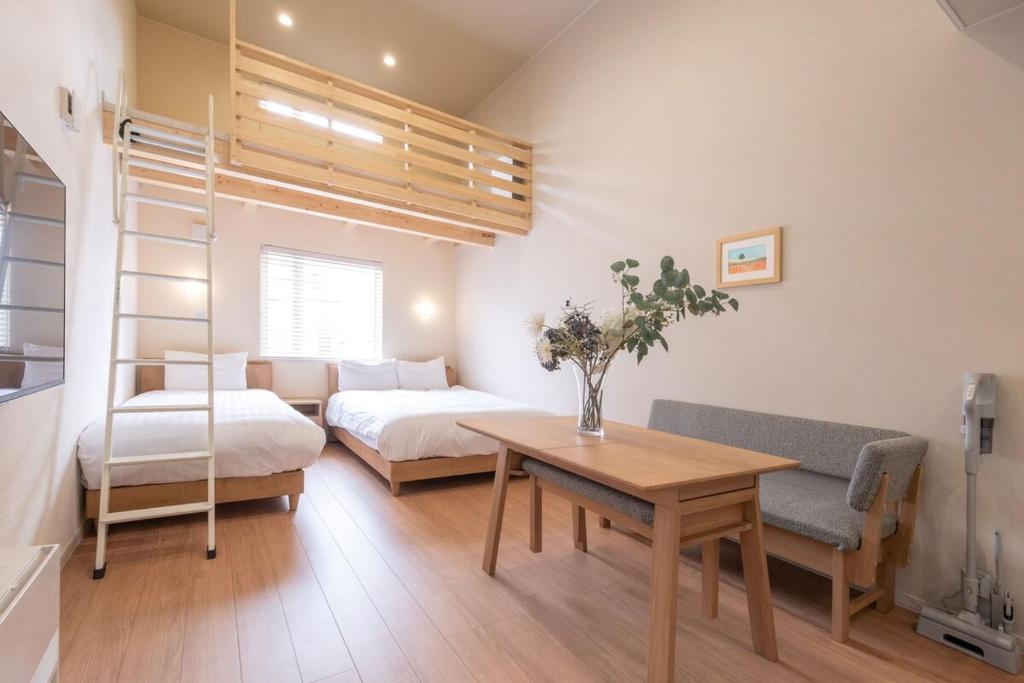 a small room with a bed and a table and a bedroom at Yukari B in Asahikawa