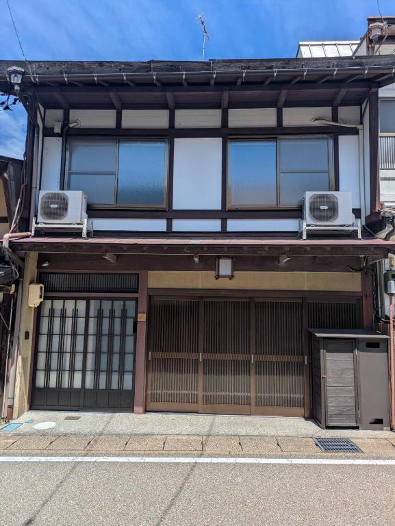 an old building with two windows and twoairconditioners at 卌屋 shioya in Gujo