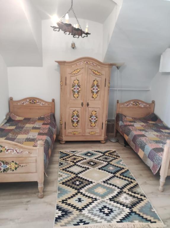a bedroom with two beds and a dresser at Levendula udvarház in Sopron