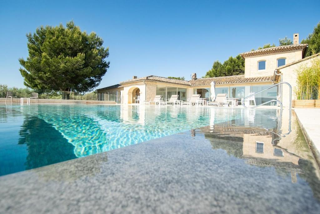 a swimming pool in front of a house at La Villa Mirau in Cavaillon