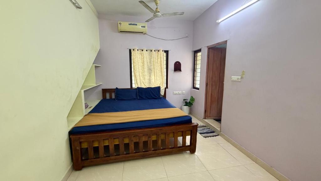 a bedroom with a bed in a room at Gravity Groups Core - Pannai veedu in Puducherry Airpoert