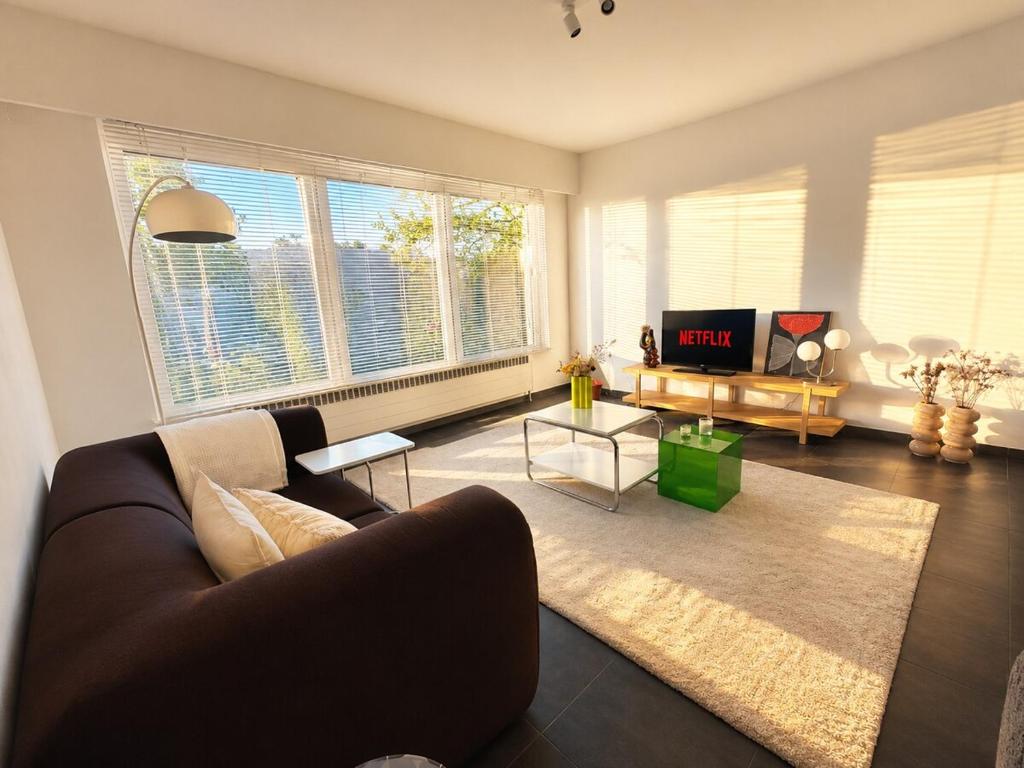 a living room with a couch and a table at Modern 2 BR apartment in Centre in Sint-Niklaas