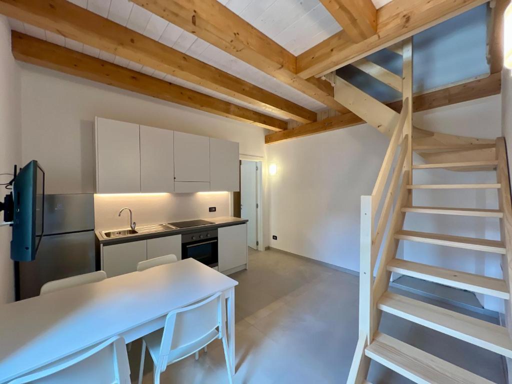 a kitchen with a staircase leading up to a loft at Piazza Maggiore Charming Apartament in Santa Maria Maggiore