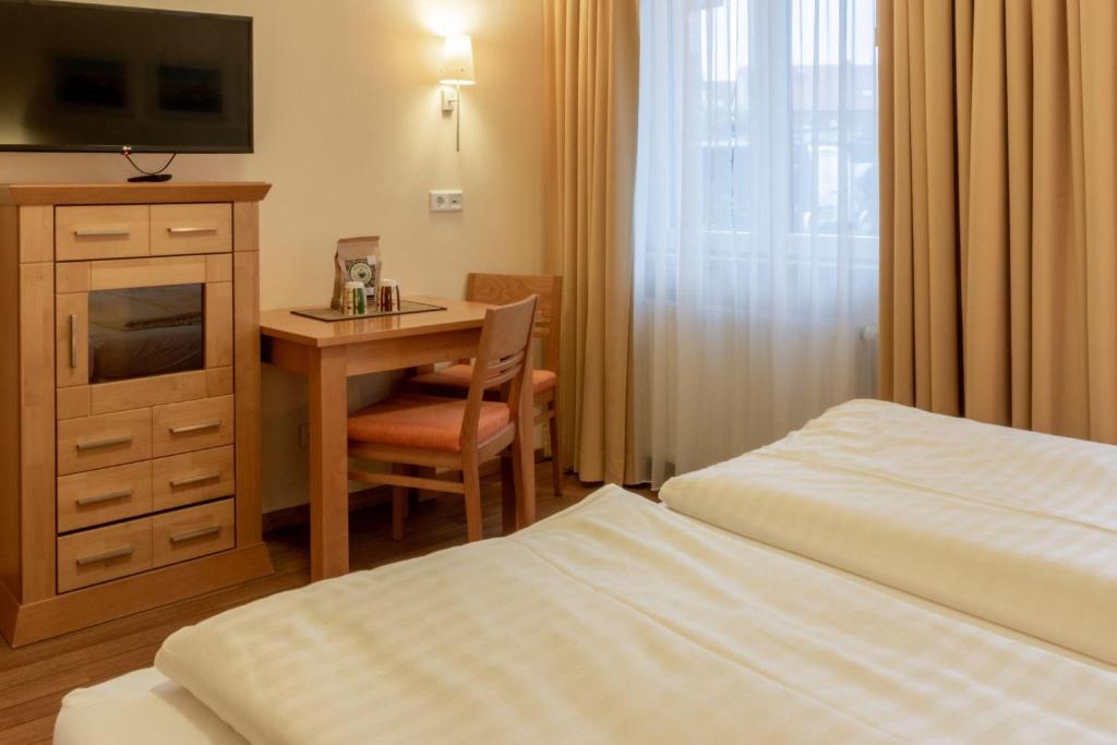 a hotel room with a desk and a bed at Hafendomicil Appartement WH05 - Maus in Waren