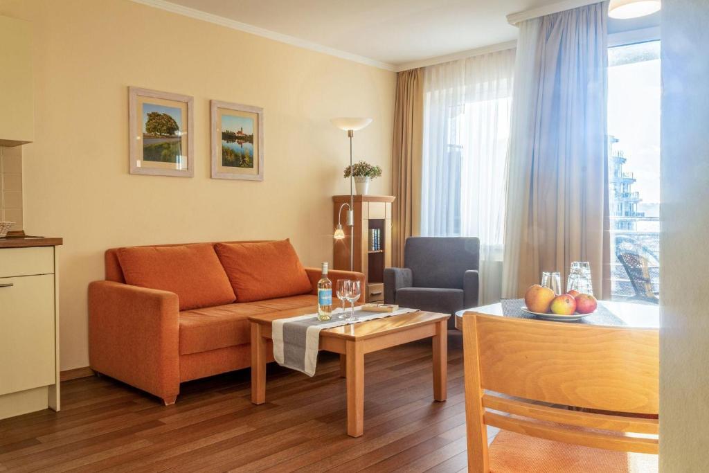 a living room with a couch and a table at Hafendomicil Appartement WH12 - Specht in Waren