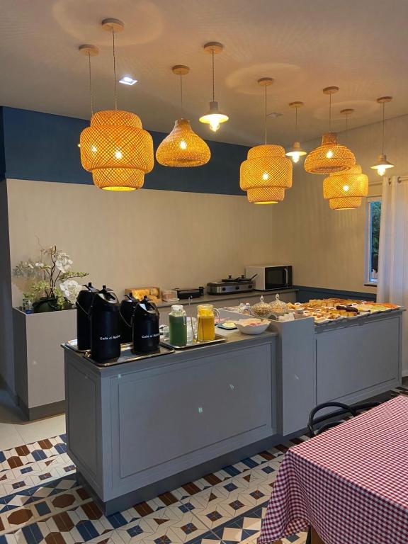 a kitchen with a counter with food on it at Hotel Mirage in Alta Floresta