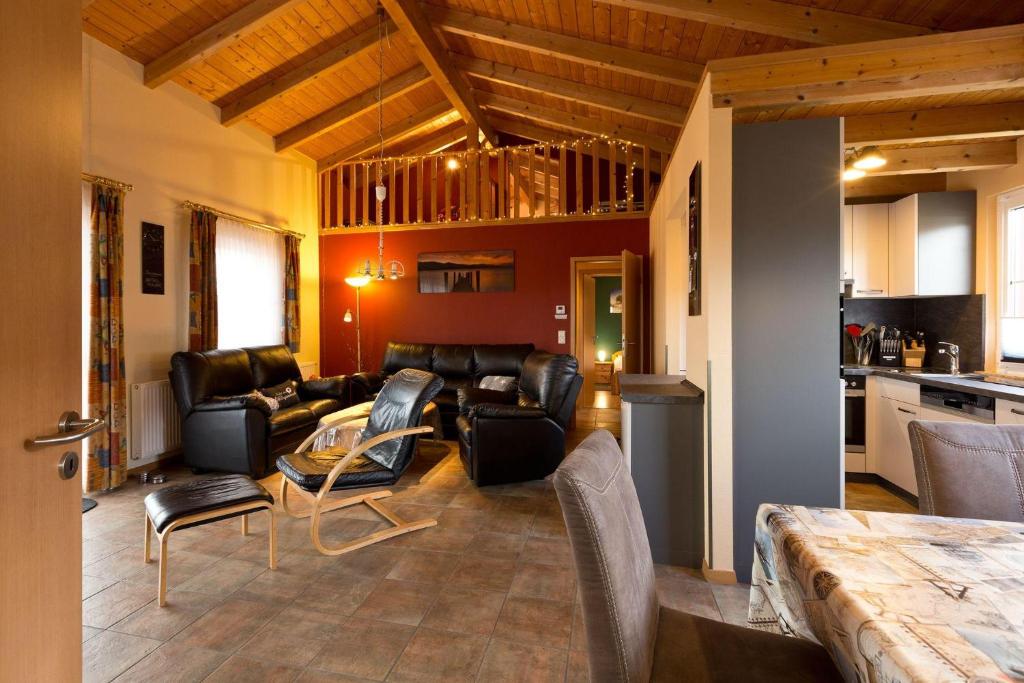a living room with leather furniture and a table at Ferienhaus Jabel 28 in Jabel