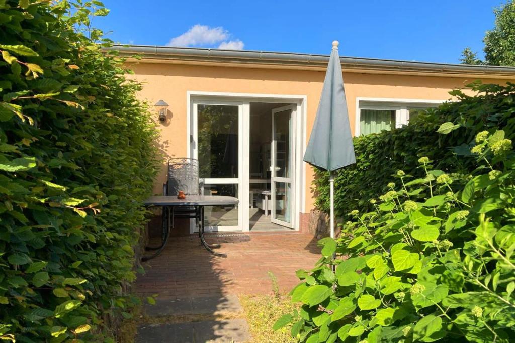 a patio with a table and an umbrella at UG-Birke in Göhren-Lebbin
