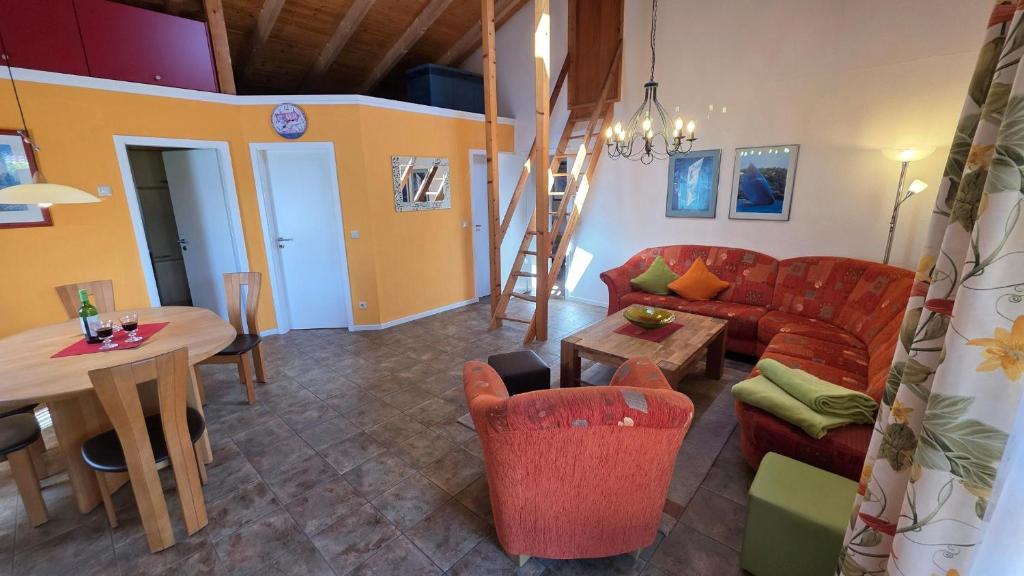 a living room with a red couch and a table at Ferienhaus Jabel 30 in Jabel
