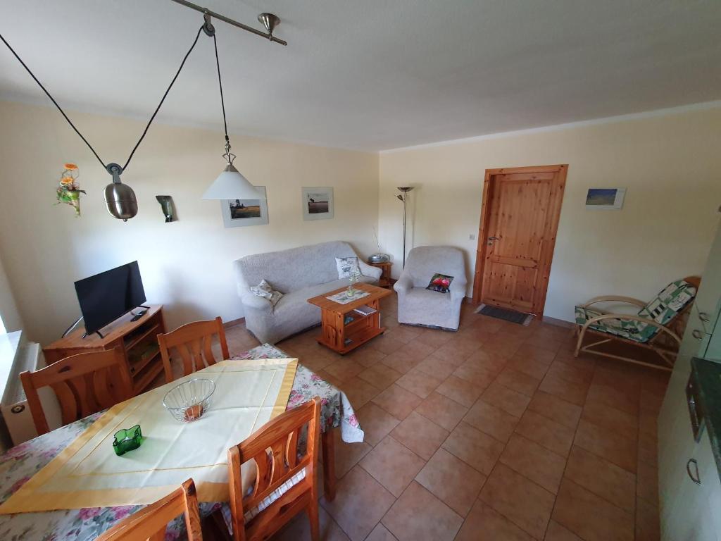 an overhead view of a living room with a table and chairs at Tannenblick Loppin EG in Jabel