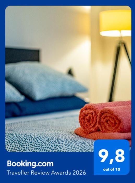a picture of a bed with a red towel on it at Apartments Częstochowa - Słoneczna Kamienica - Centrum - Prywatny Parking free! - Klimatyzacja ! in Częstochowa