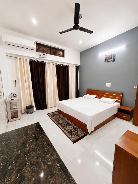 a bedroom with a bed and a ceiling fan at Ramaya Retreat Ayodhya in Faizābād
