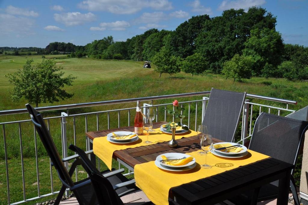 a table on a balcony with a view of a field at Fair-Play App 04 DG R in Göhren-Lebbin