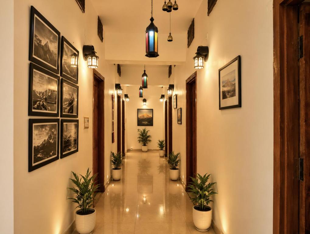 a hallway with potted plants and pictures on the walls at The Yak House in Chakrāta
