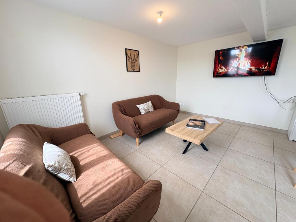 a living room with a couch and a coffee table at Le Cerf in Montmacq