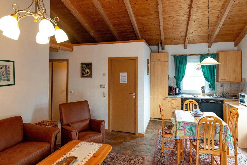 a living room with a table and a kitchen at Ferienhaus Jabel 26 in Jabel