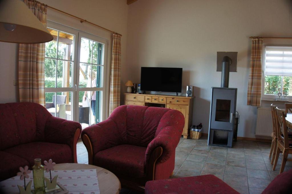a living room with two chairs and a television at Ferienhaus Jabel 29 in Jabel