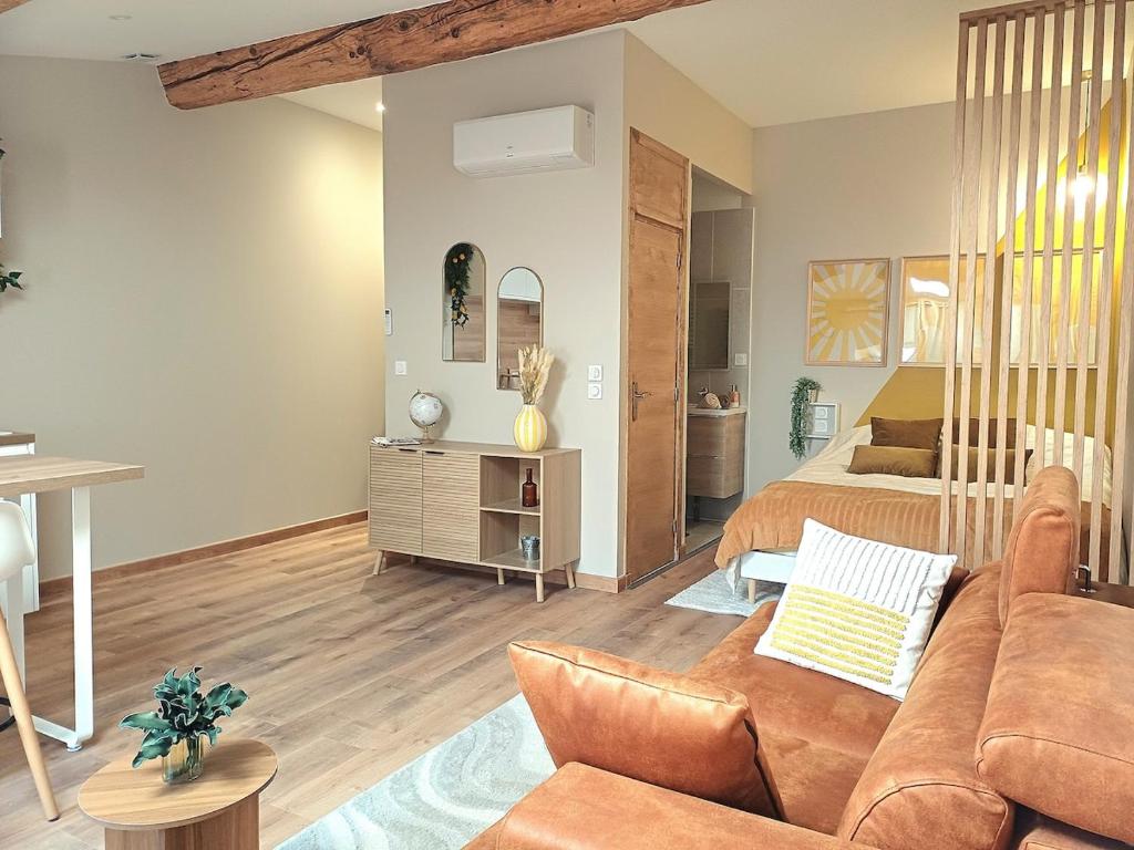 a living room with a couch and a bed at Studio cosy Le3bis proche Cap d'Agde in Bessan