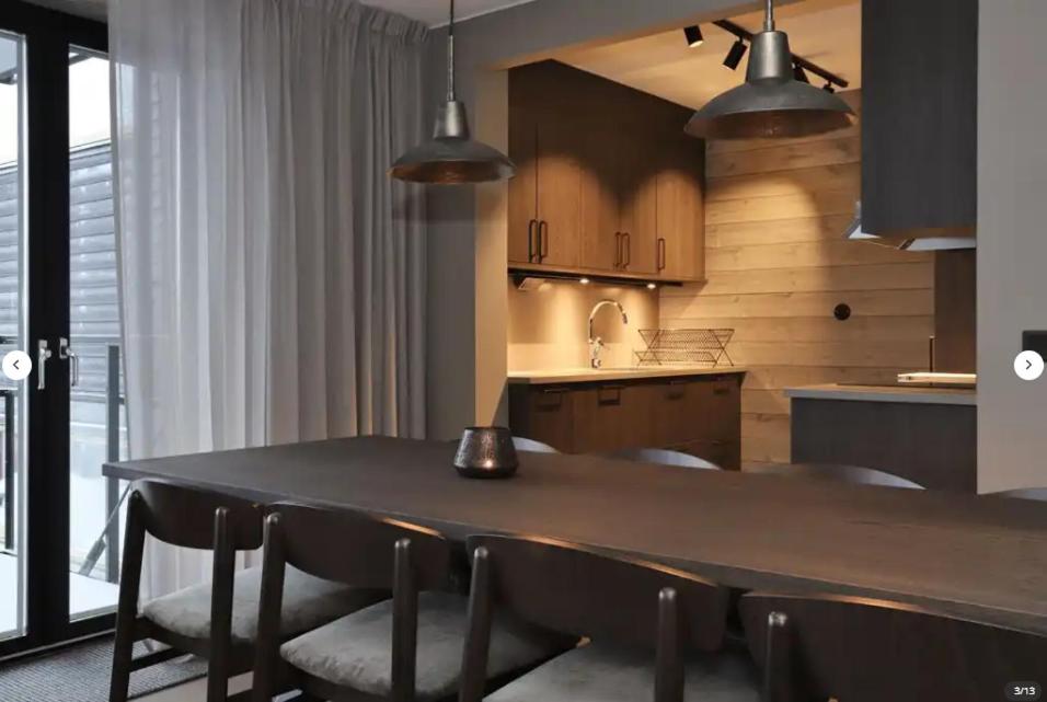 a kitchen with a table and chairs in a room at Skistar Lodge Hemsedal in Hemsedal