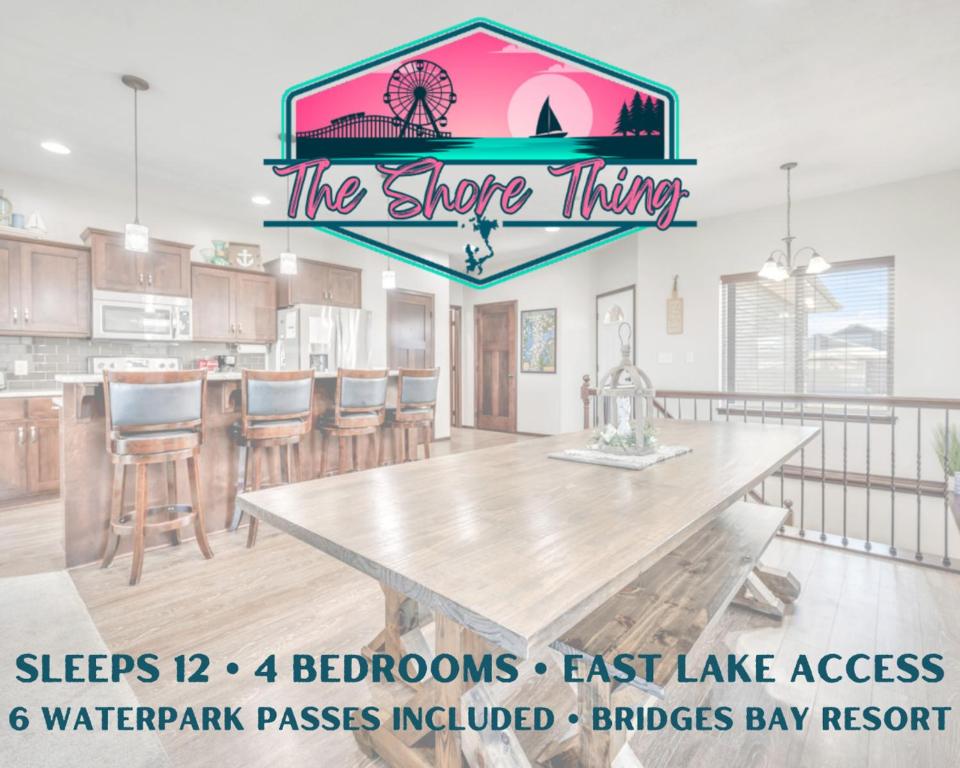 a kitchen with a large table and a dining room at Bridges Bay Vacation Cabin 185 in Arnolds Park