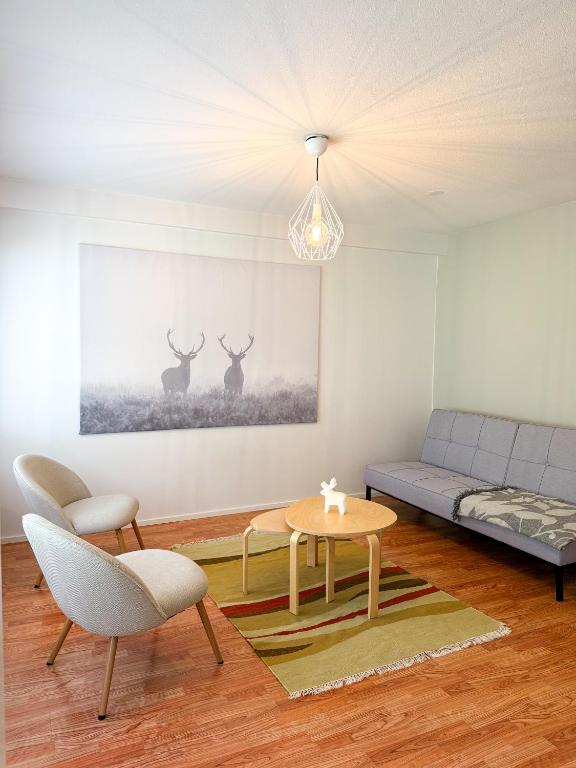 a living room with a couch and a table at Aurora Nest in Rovaniemi
