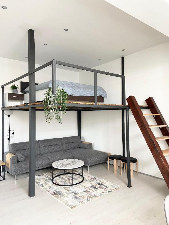 a living room with a loft bed and a couch at ETALON in the heart of Novi Sad in Novi Sad