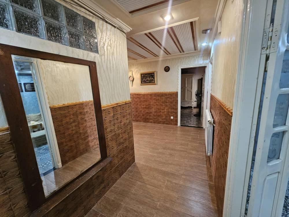 a hallway of a building with a mirror on the wall at Café de Mazagran in Mostaganem