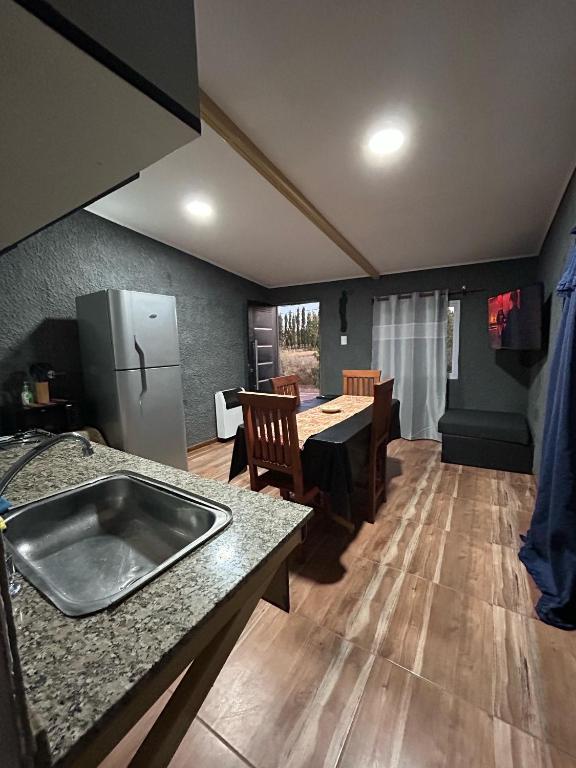 a kitchen and dining room with a sink and a table at EstadiaMalargue in Malargüe